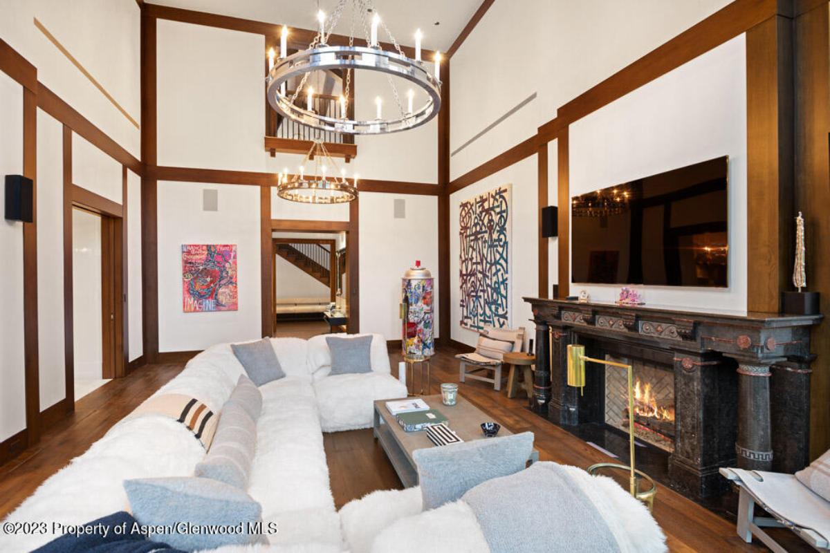 Family room with couches, fireplace and a TV.