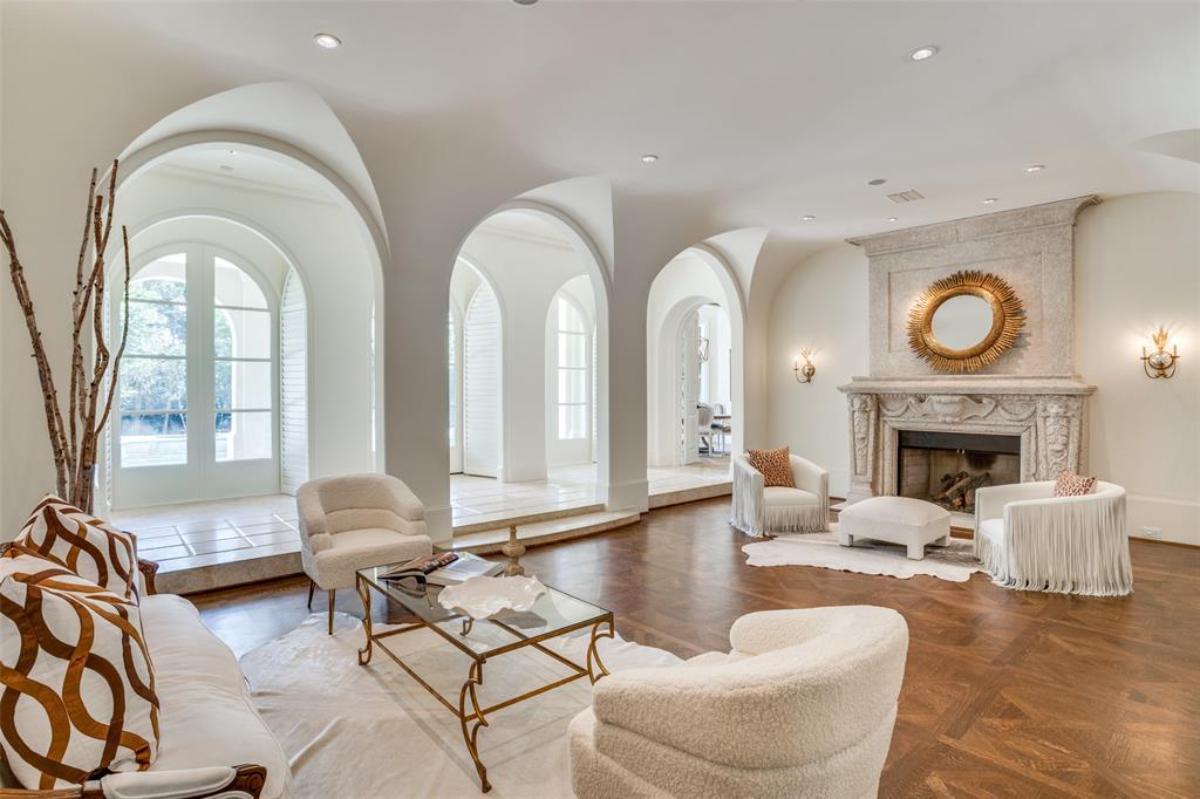 Living room with chairs and a fireplace.