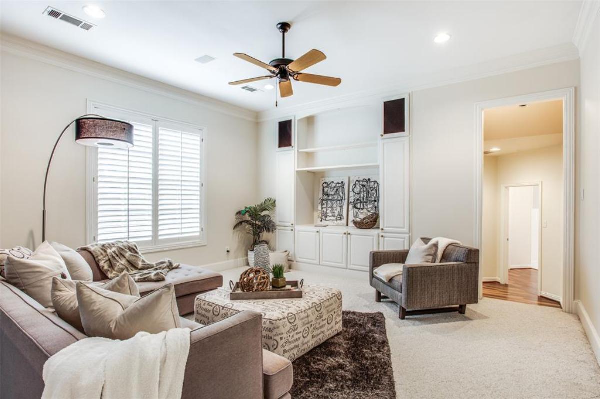 Family room with couches and carpet flooring.