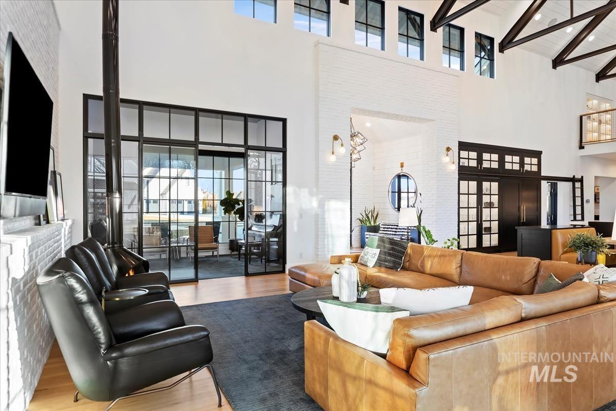 Living room with couches, chairs, and a large rug.