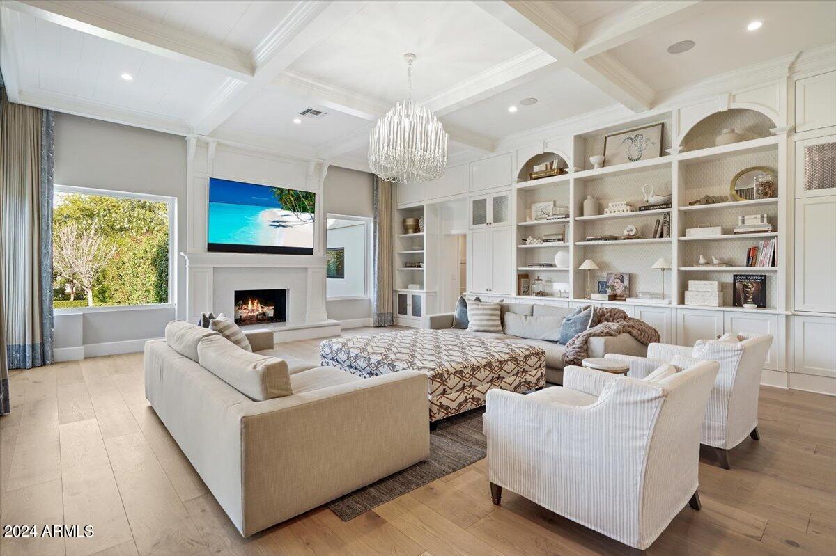 Living room with couches, TV and a fireplace.