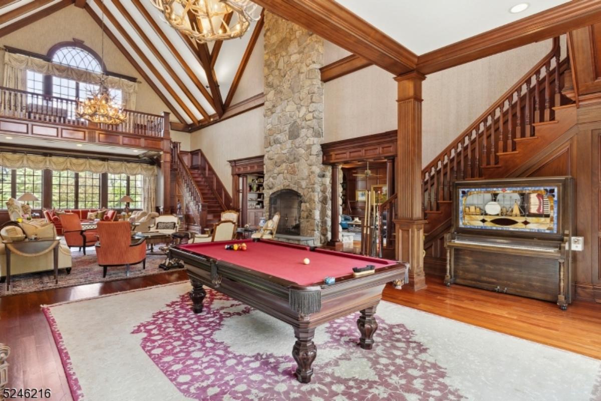 Game room with a pool table and a large rug.