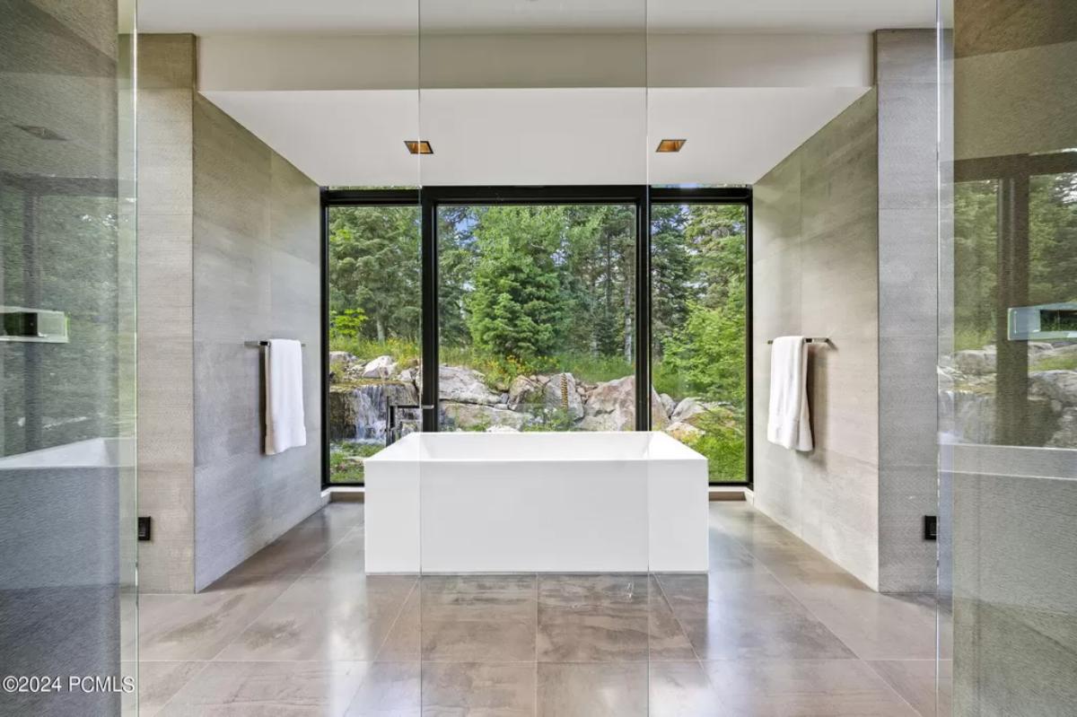 Bathroom with a soaking tub and glass doors.