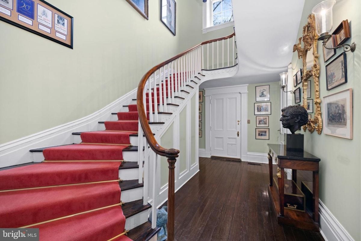 The staircase features hardwood flooring and a handrail.
