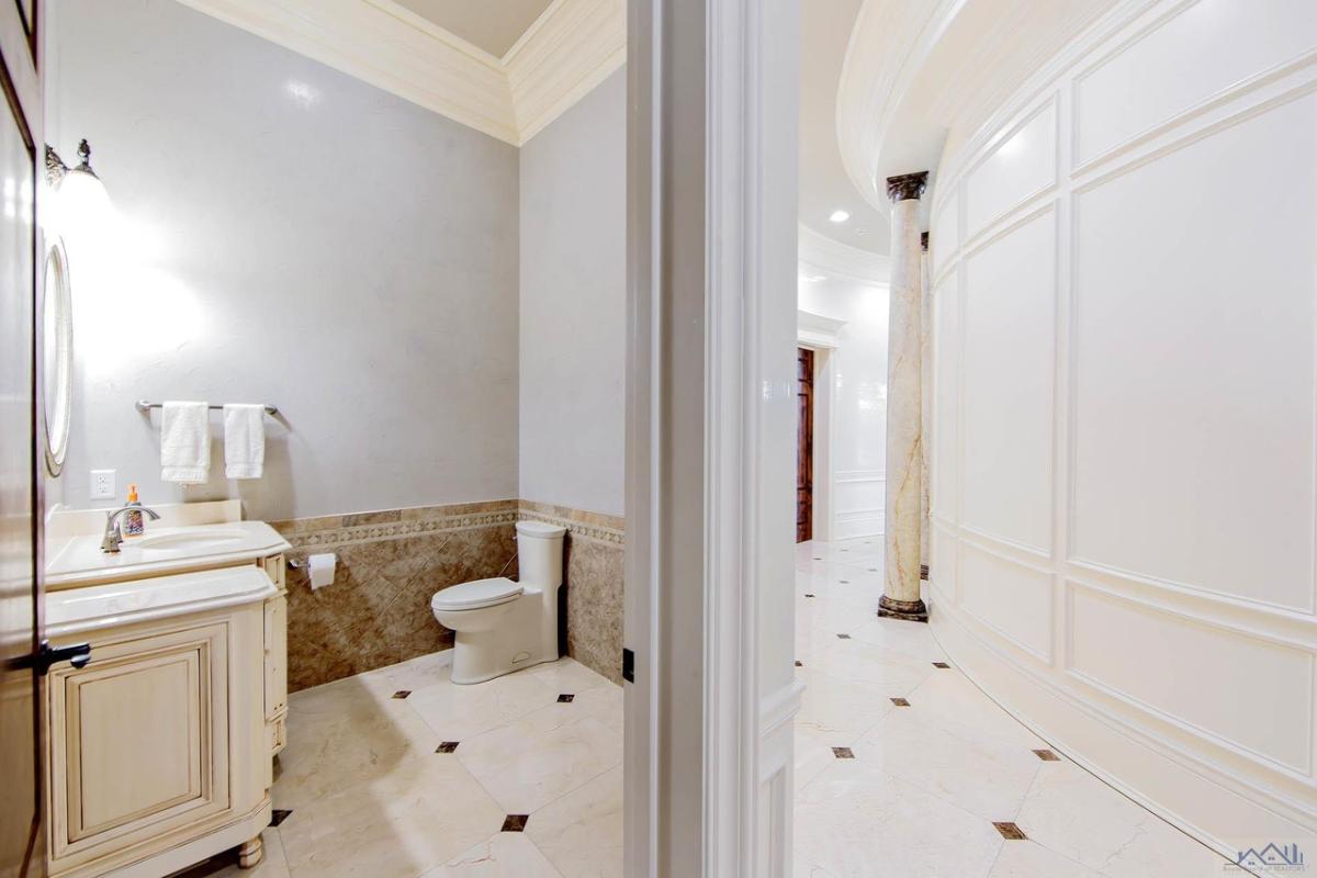 Bathroom with a toilet, sink and mirror.