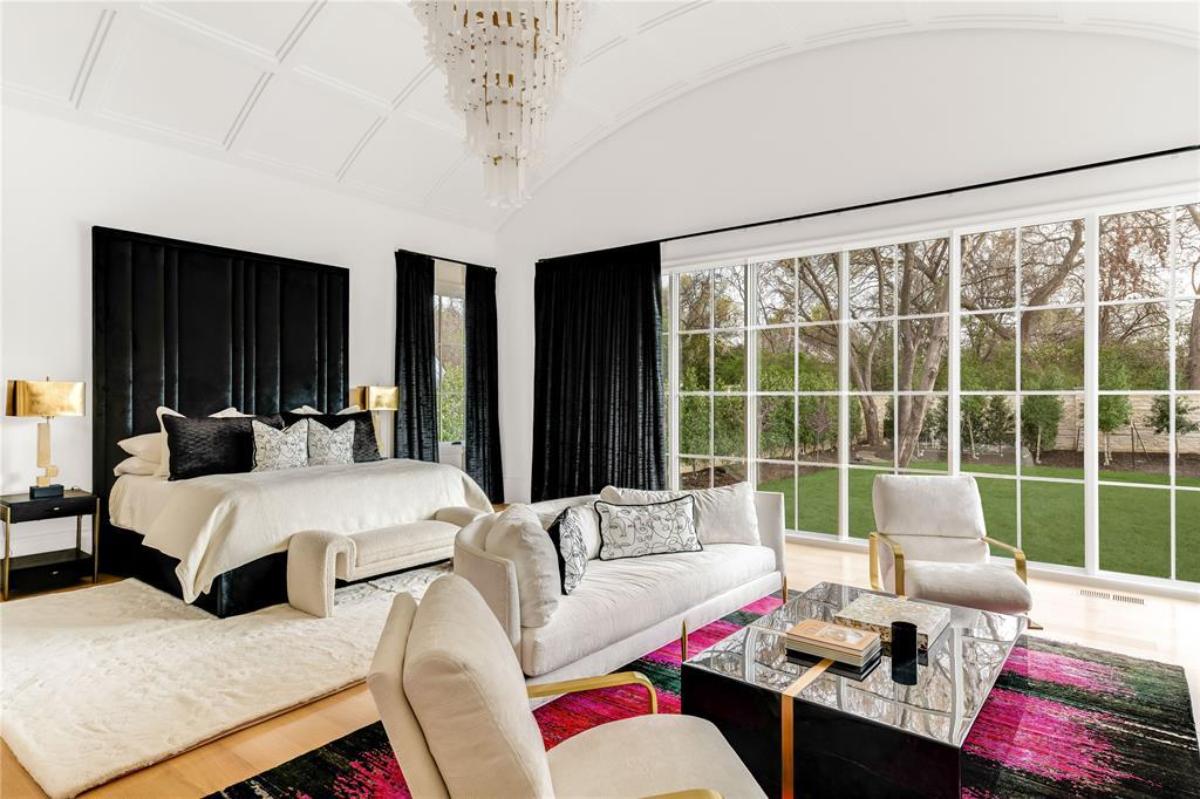 Bedroom with a chandelier and glass windows.