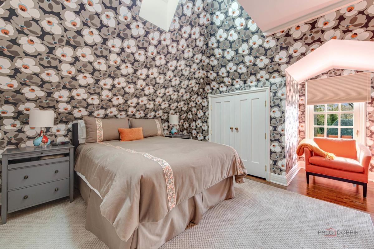 Bedroom with a large bed, and a large rug.