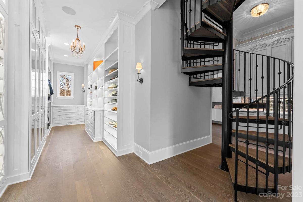 Staircase with metal railings and wooden steps.