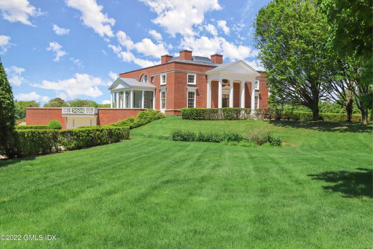 A lawn with green grass and trees.