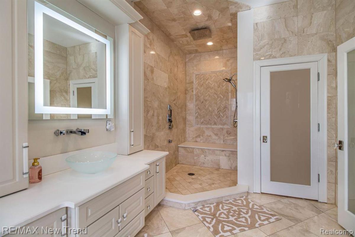 Bathroom with a sinks, mirror, soaking tub, shower and tile flooring.