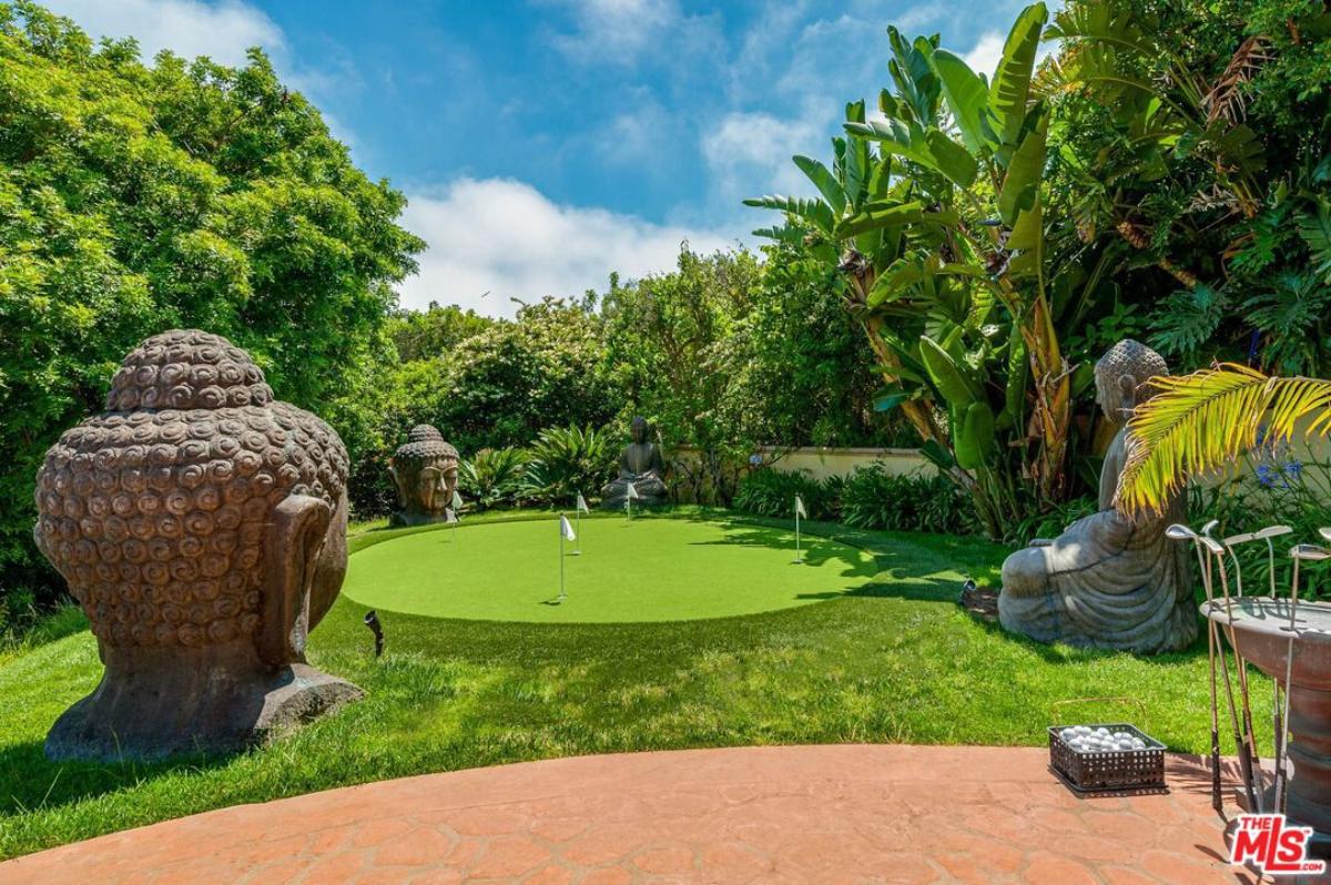 Golf course with trees in the background.