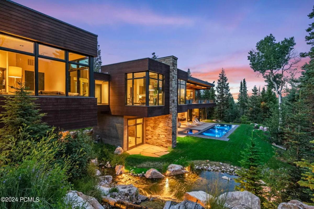 Exterior view of the mansion with a pool and waterfalls.