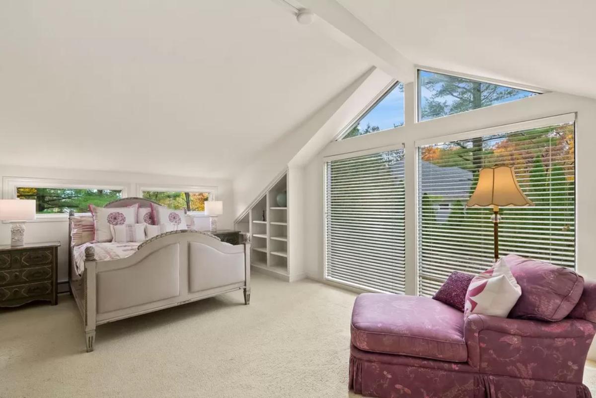 Bedroom with a large bed and carpet flooring.