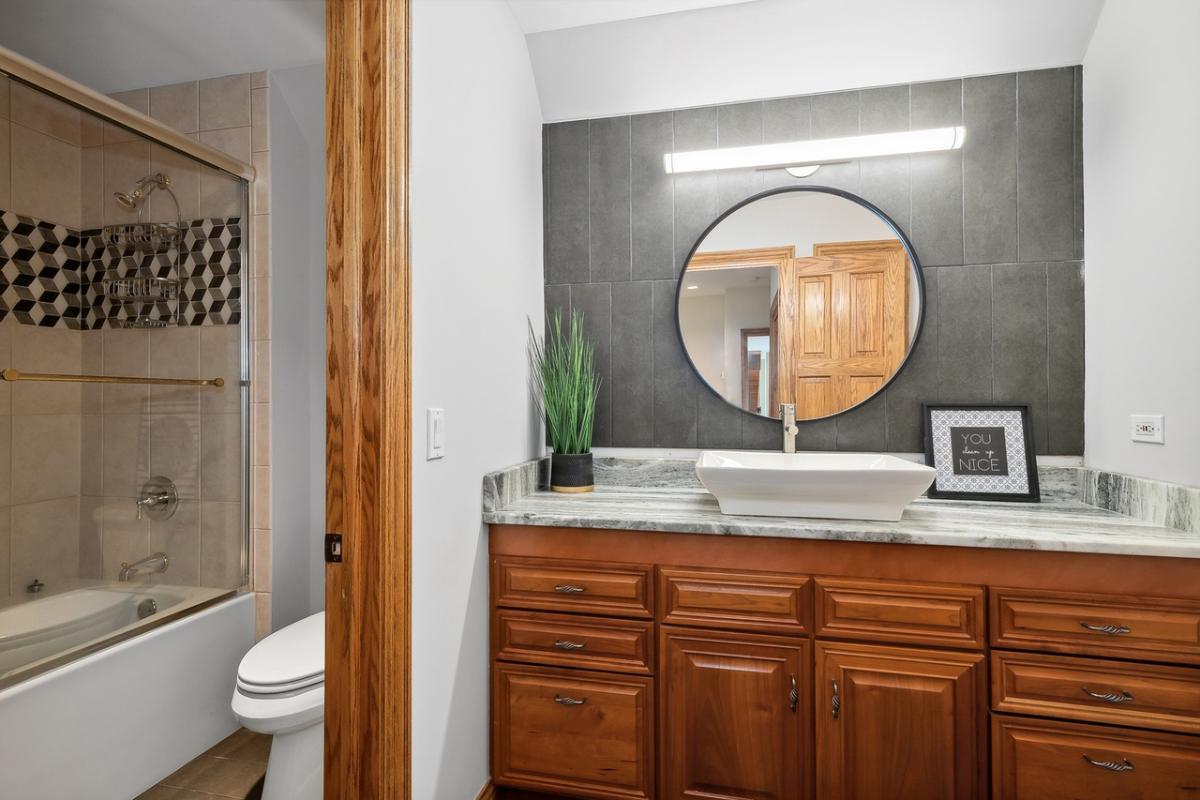 Bathroom with a sink, toilet and a soaking tub.