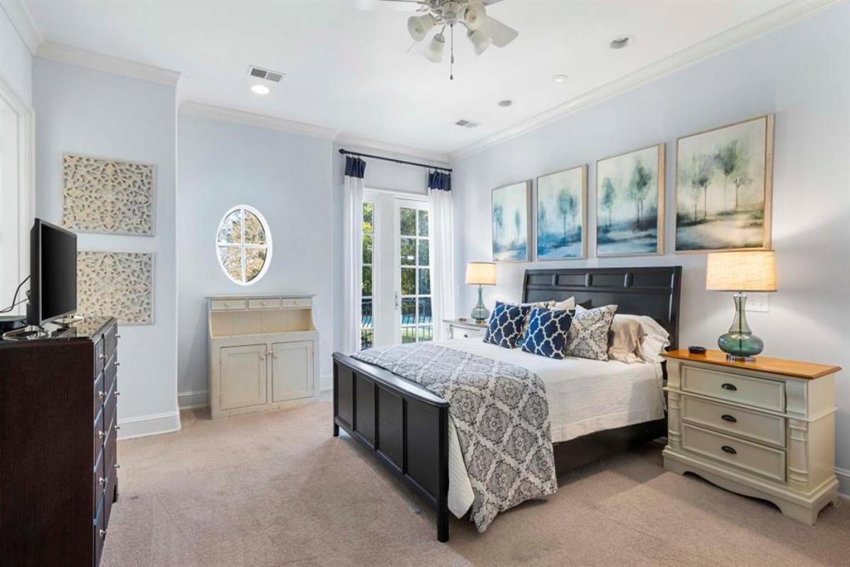 Bedroom with carpet flooring and glass windows.