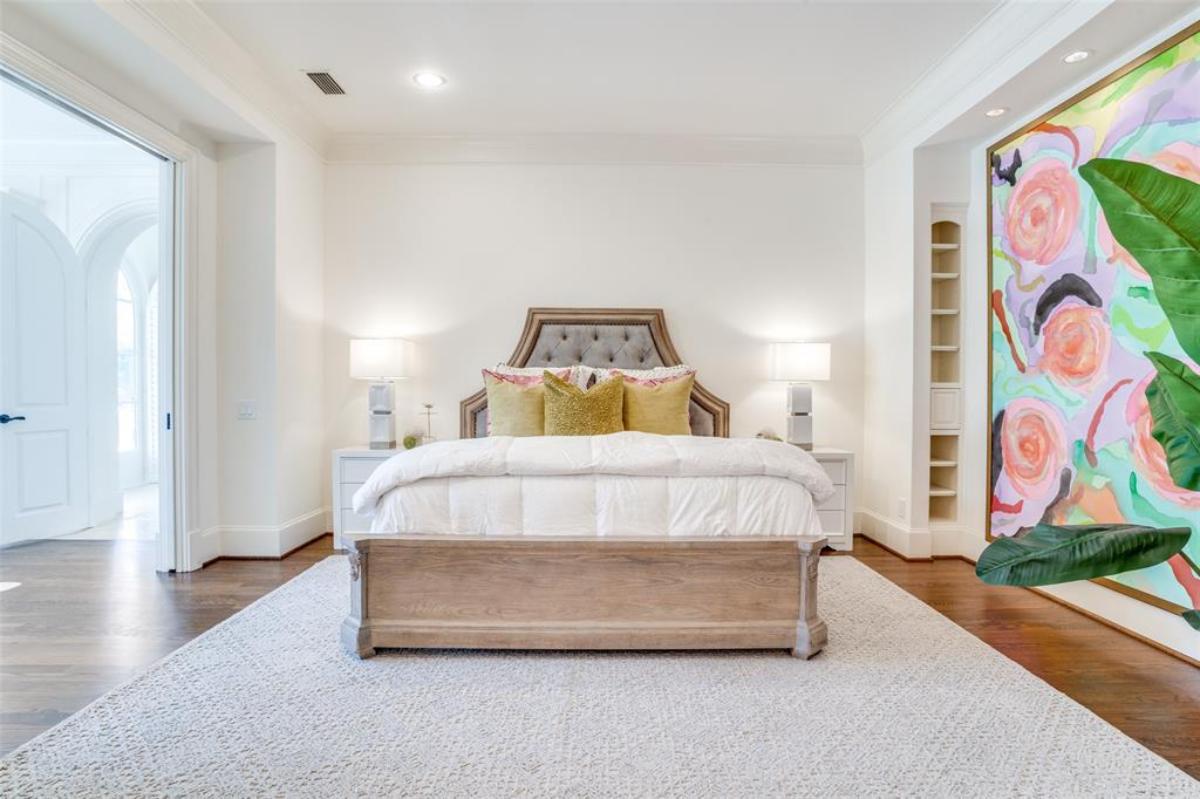 Bedroom with wood flooring and a large rug.