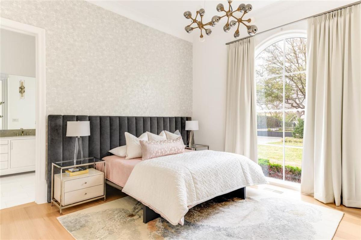 Bedroom with wood flooring and glass windows.