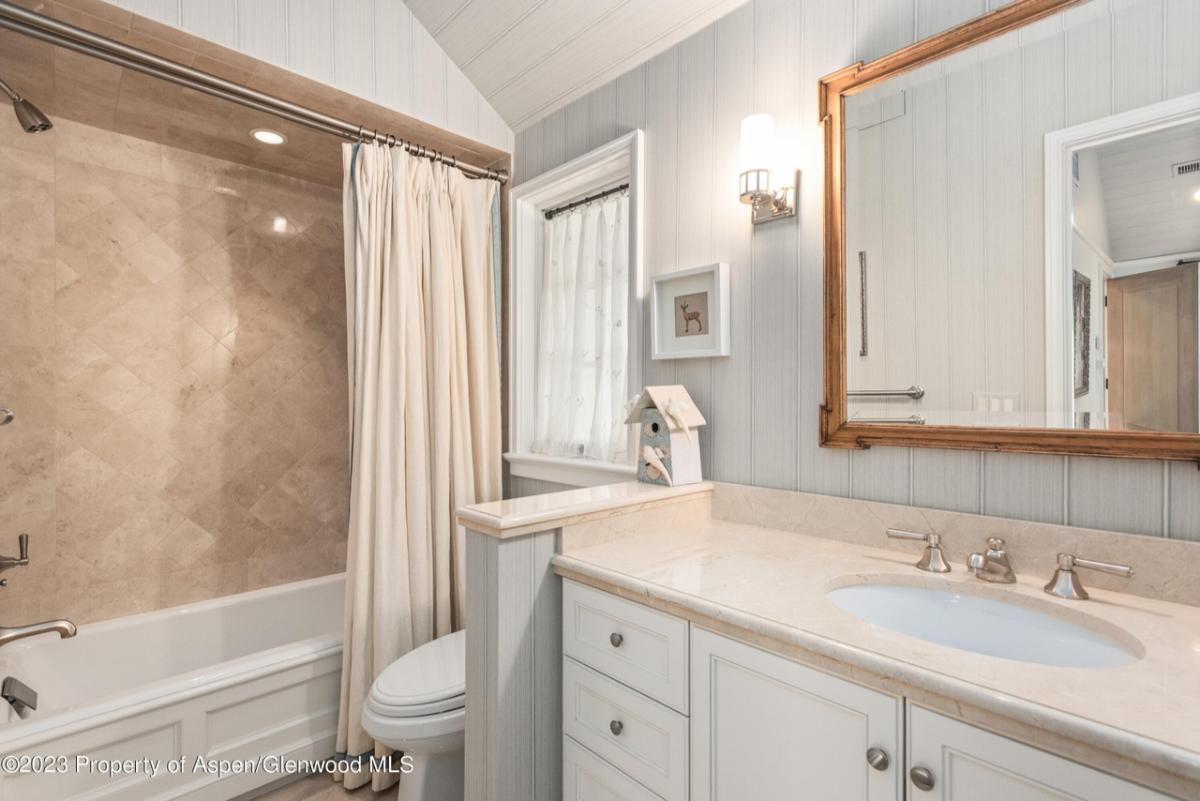 Bathroom with a toilet, sink, shower and soaking tub.