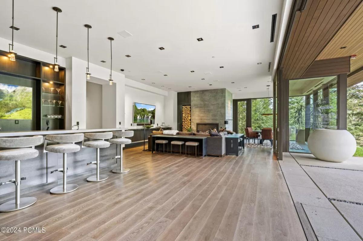 Great room with a living area, dining area and a bar.