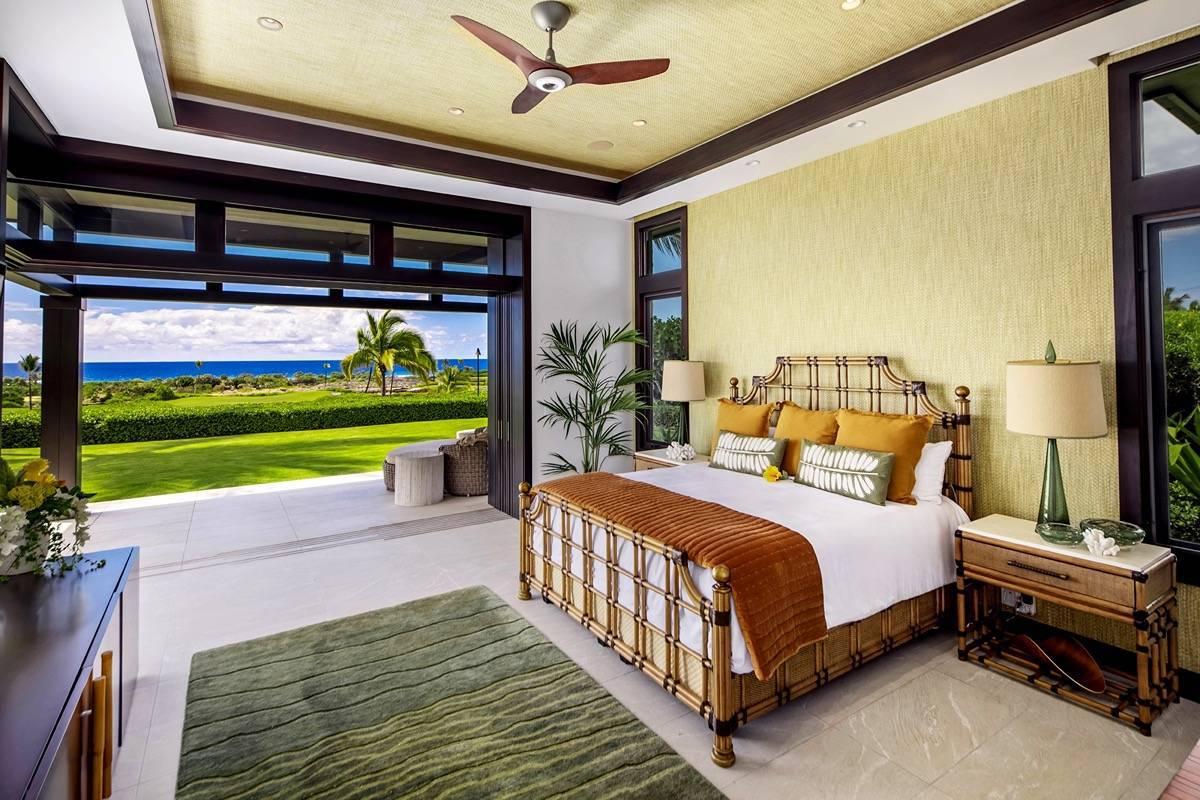 Bedroom with a large bed, ceiling fan and a large rug.