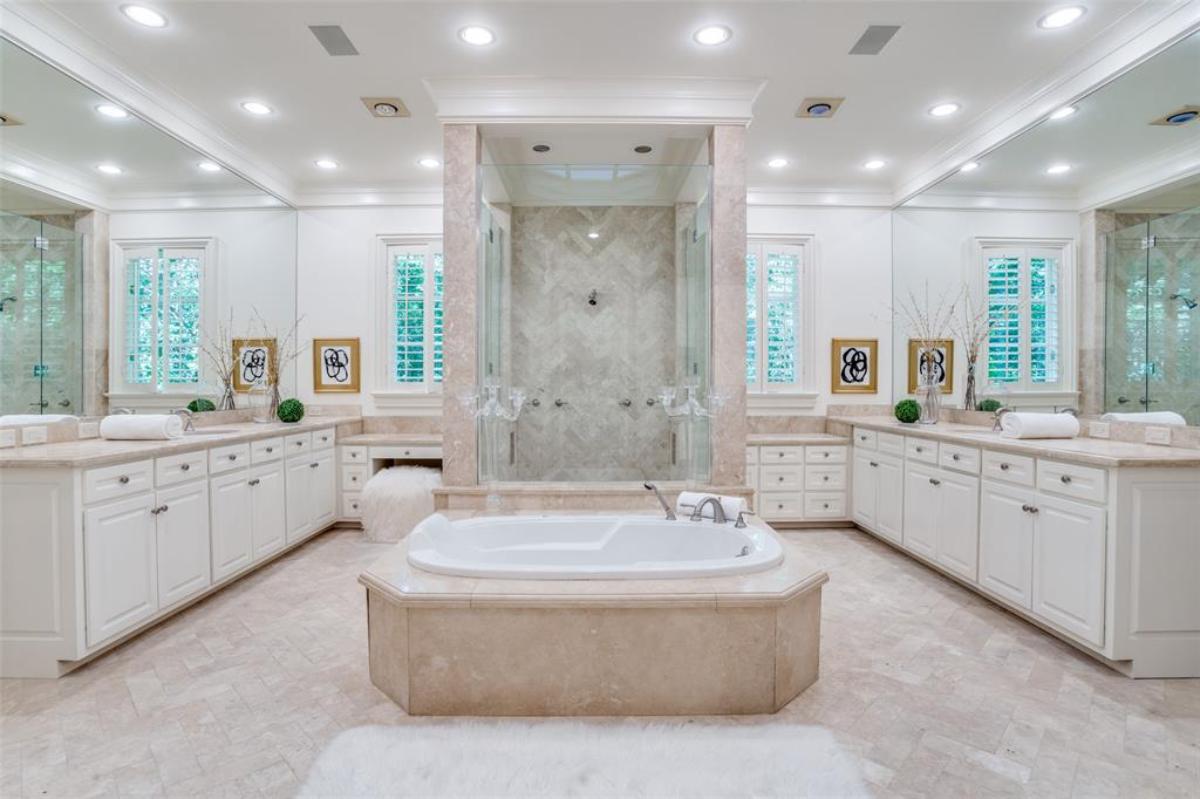 Bathroom with sinks, walk-in shower and a soaking tub.
