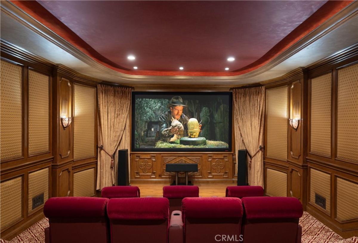 Home theater with a large screen and custom lights.