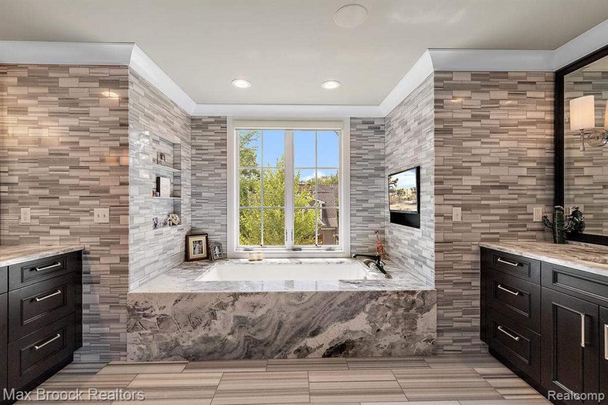 Bathroom with a soaking tub and glass windows.