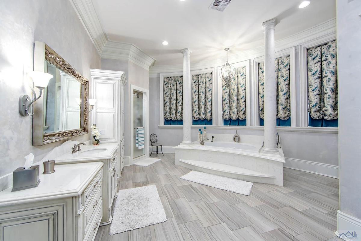 Bathroom with a sink, mirror and a soaking tub.
