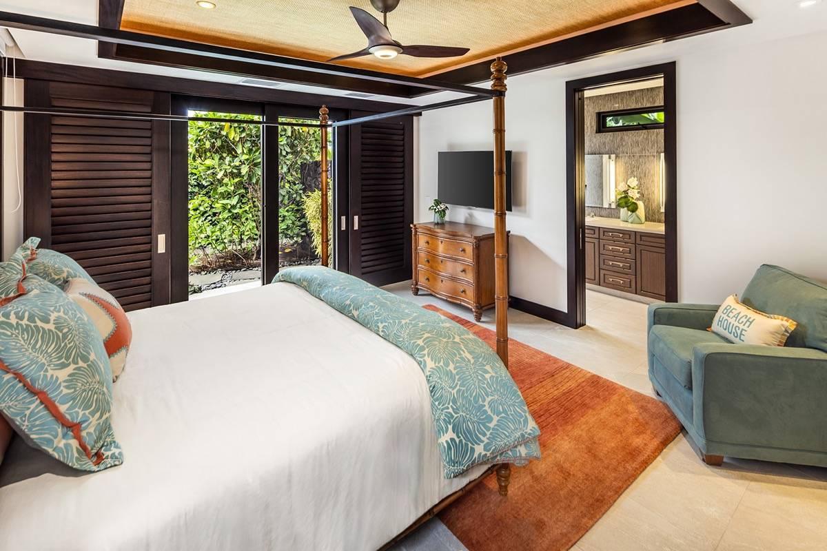 Bedroom with a large bed, ceiling fan and a large rug.