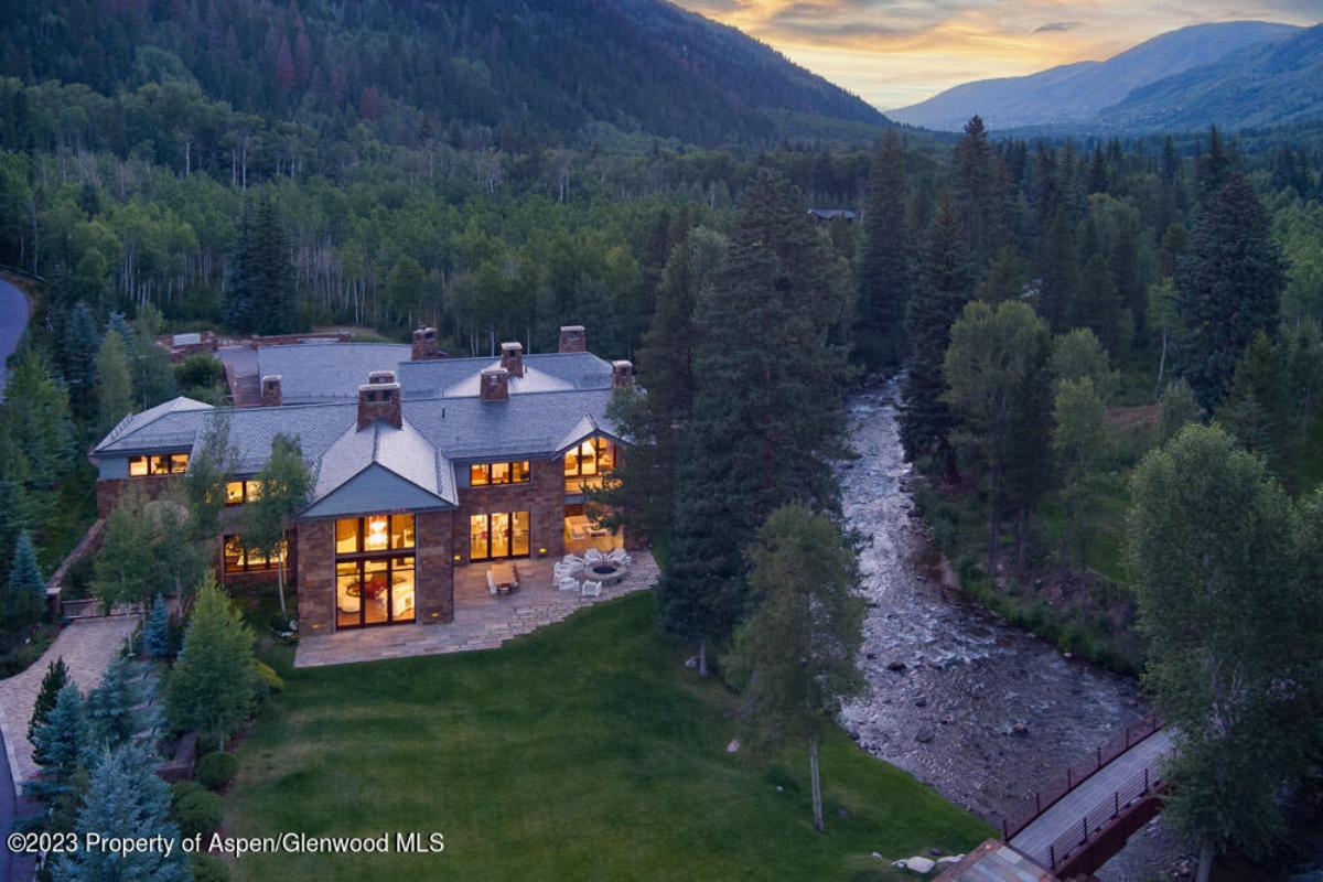 Aerial view of the property with a river and a bridge.