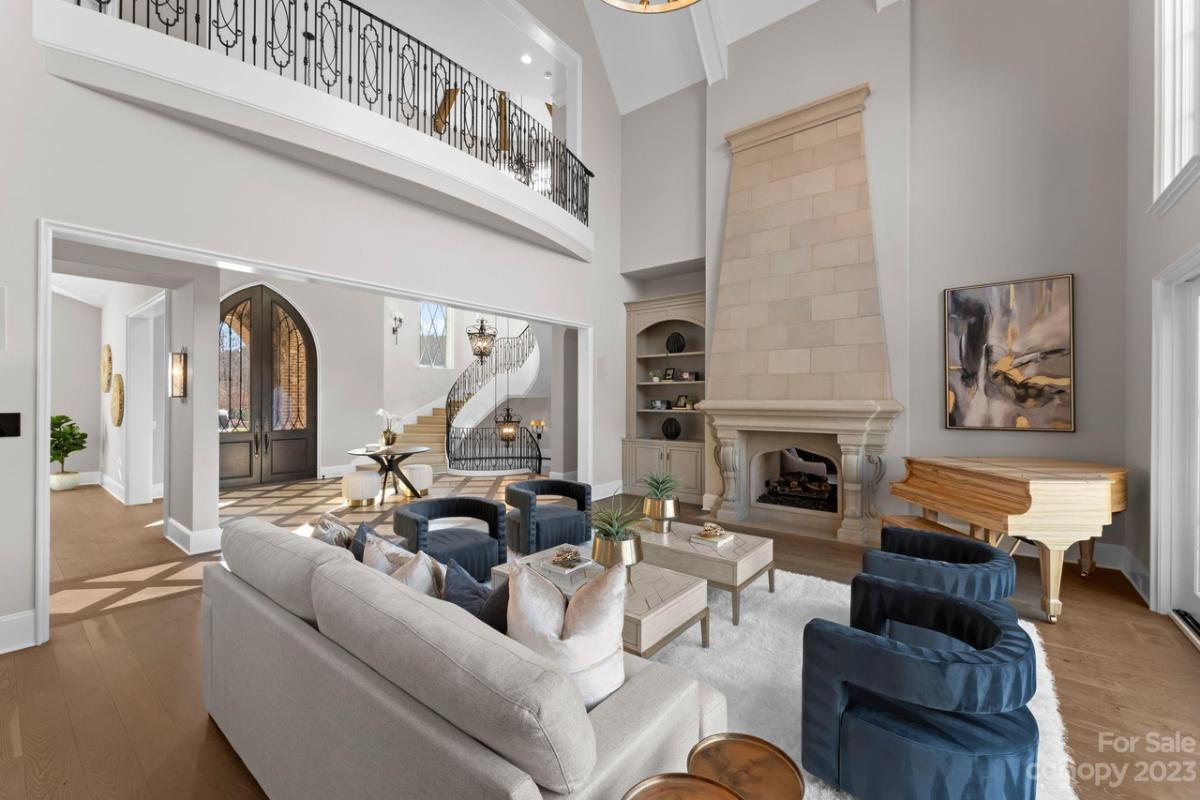 Living room with a couch, large rug and a fireplace.