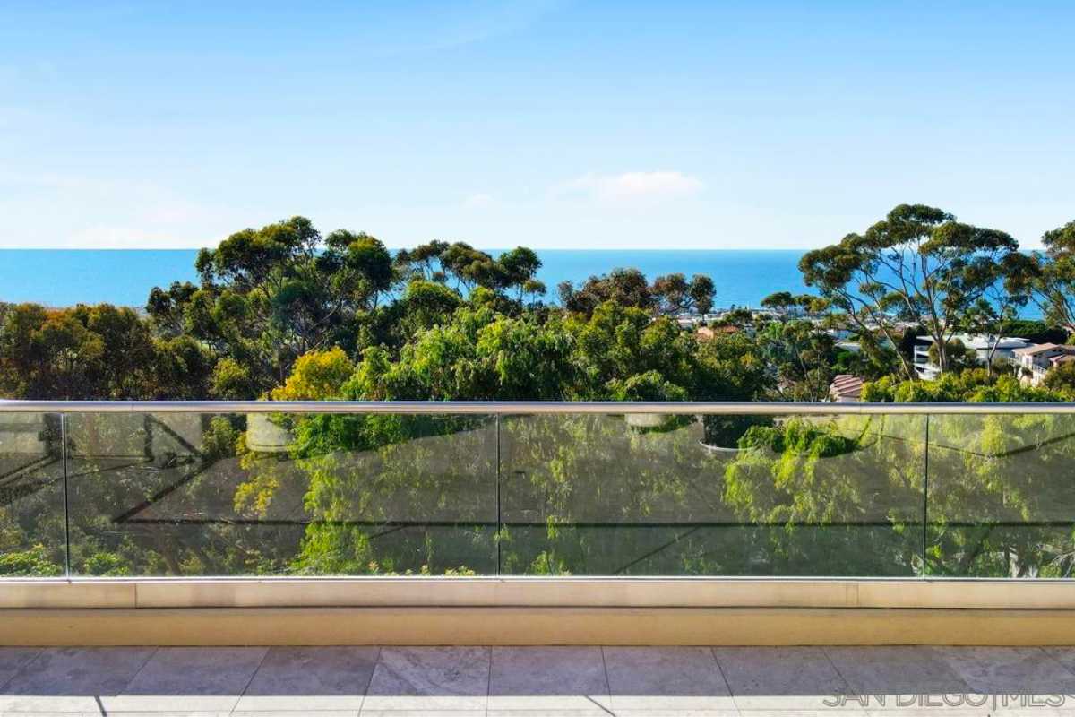 A balcony with a glass railing.