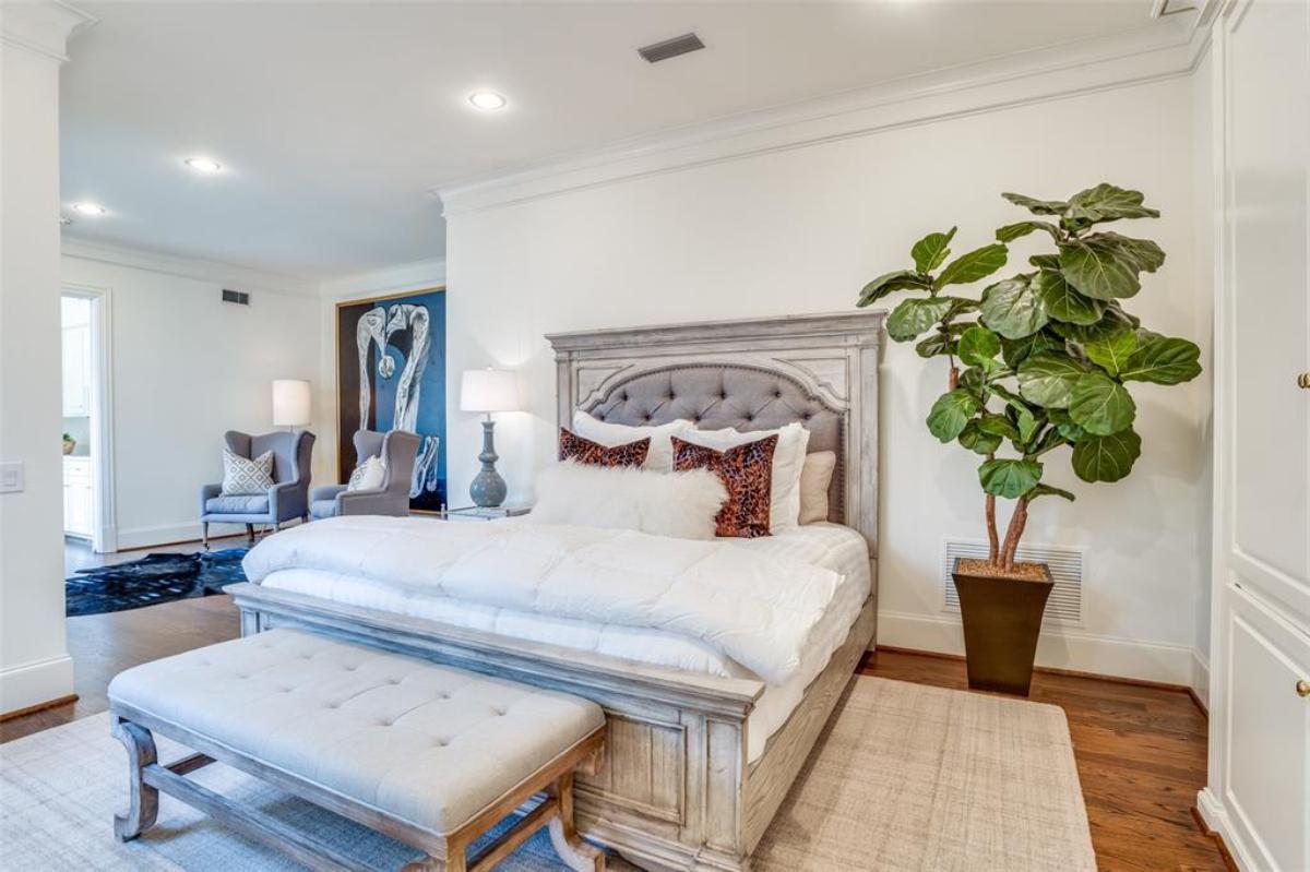 Bedroom with wood flooring and a large rug.