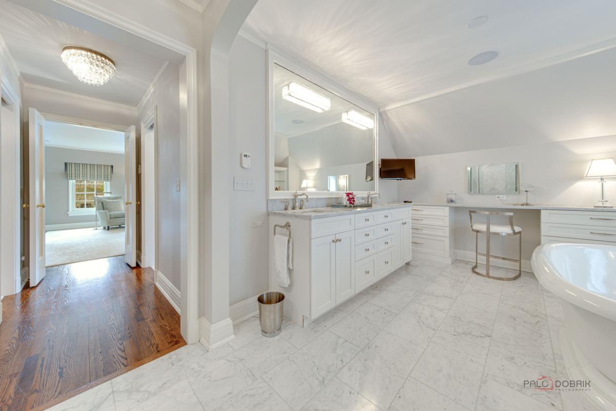 Bathroom with sink, soaking tub and a tile flooring.