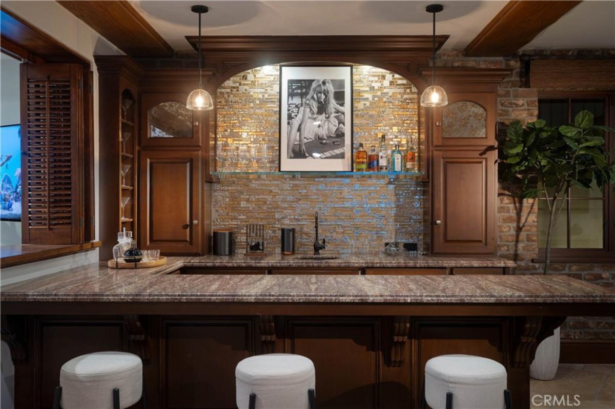 Bar with chairs and marble countertops.