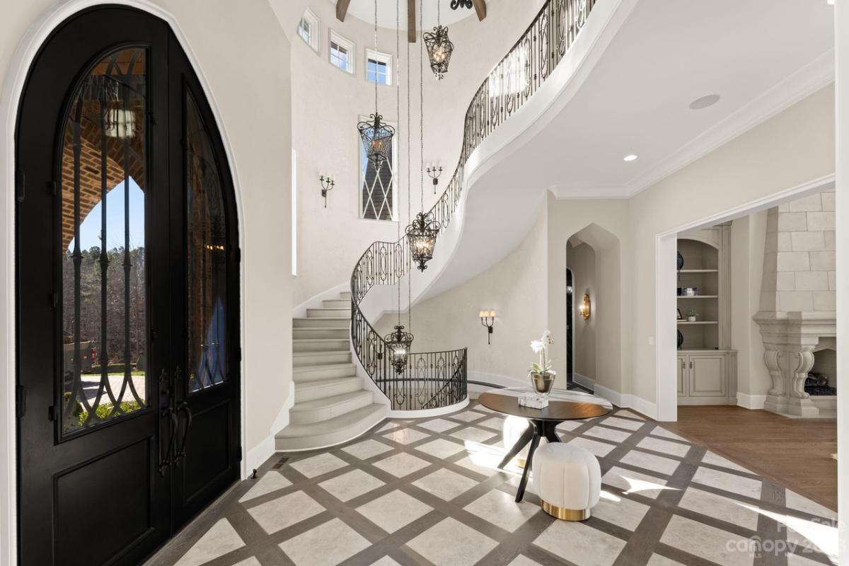 Foyer with a chandelier and staircase.