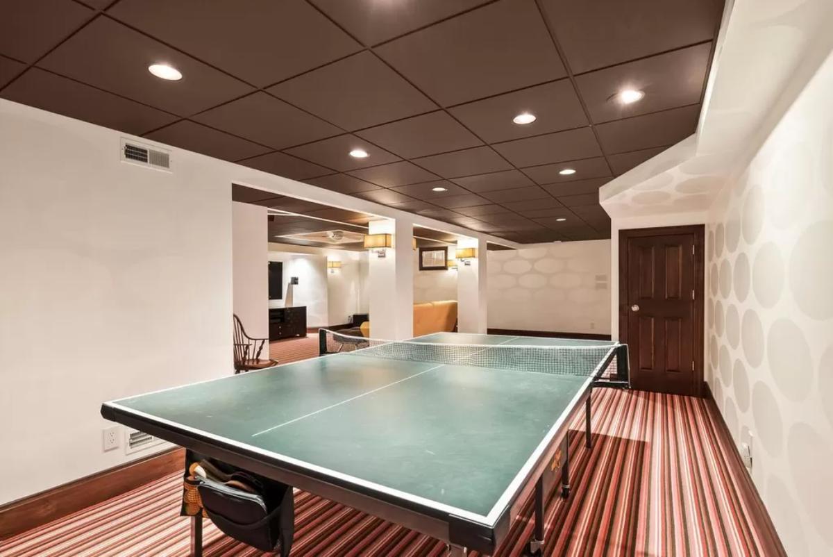 Entertainment room with a table tennis and custom lights.