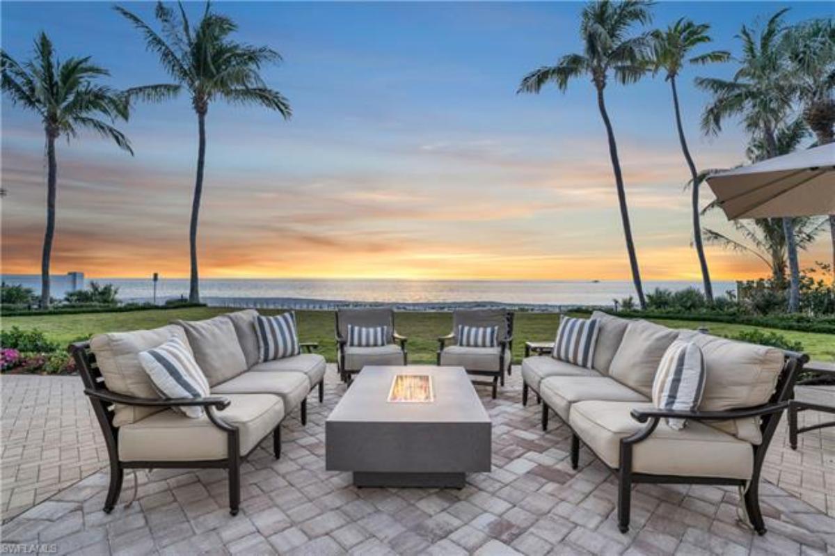 Patio with a fire pit and chairs.