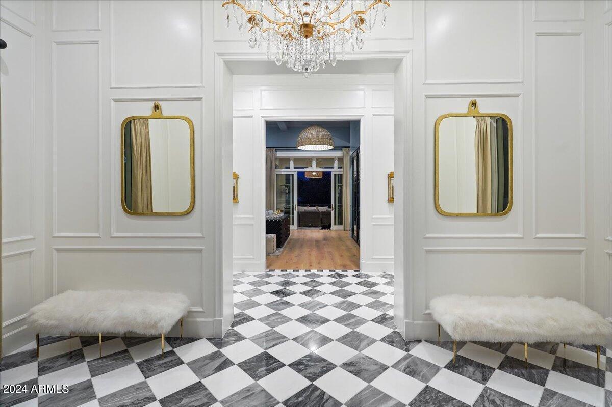 Hallway with a  chandelier.