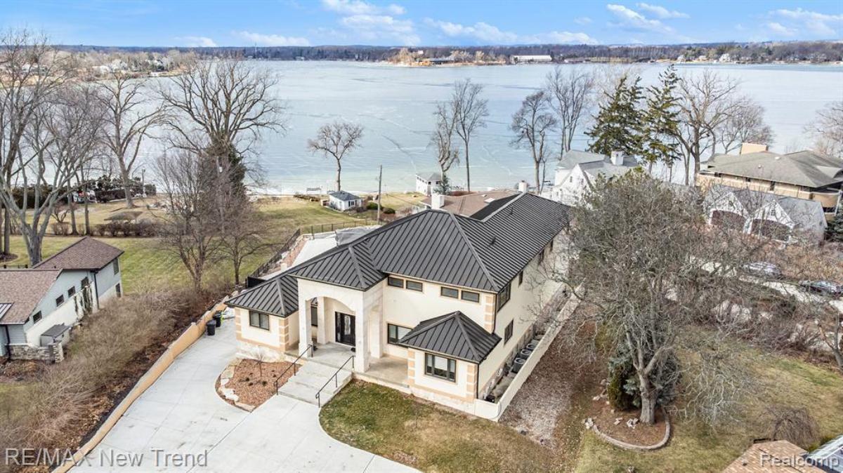 Aerial view of the property with a lake view in the background.