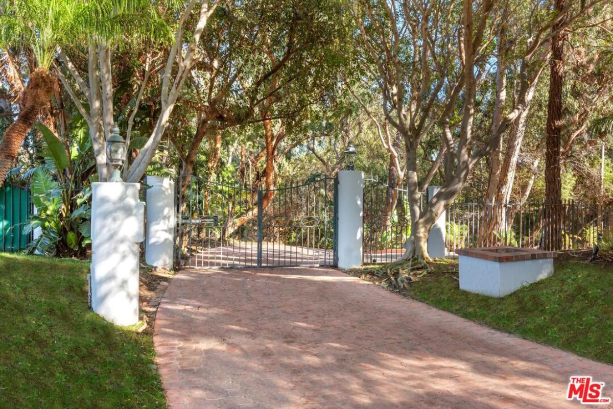 Front gate entry with a spacious driveway.