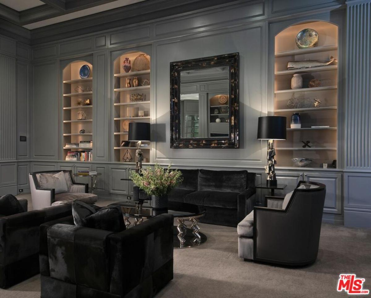 Living room with couches and shelves.