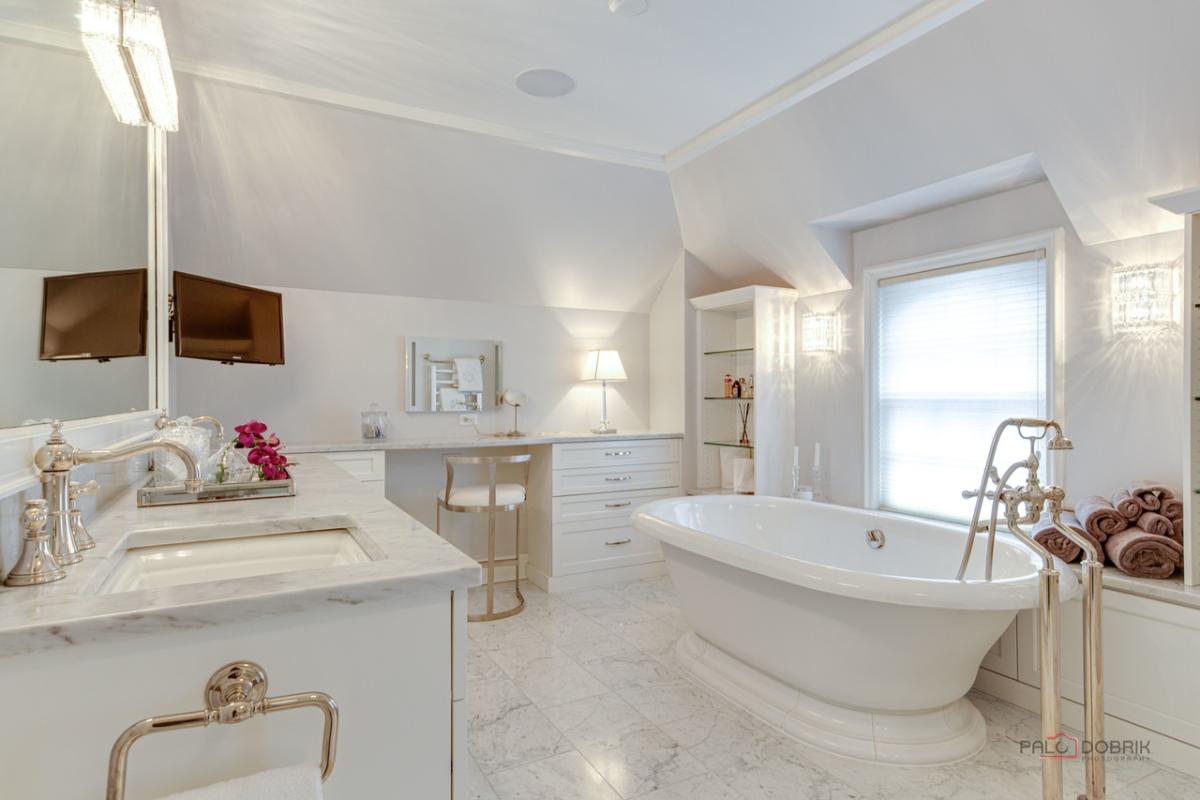 Bathroom with sink, soaking tub and a tile flooring.