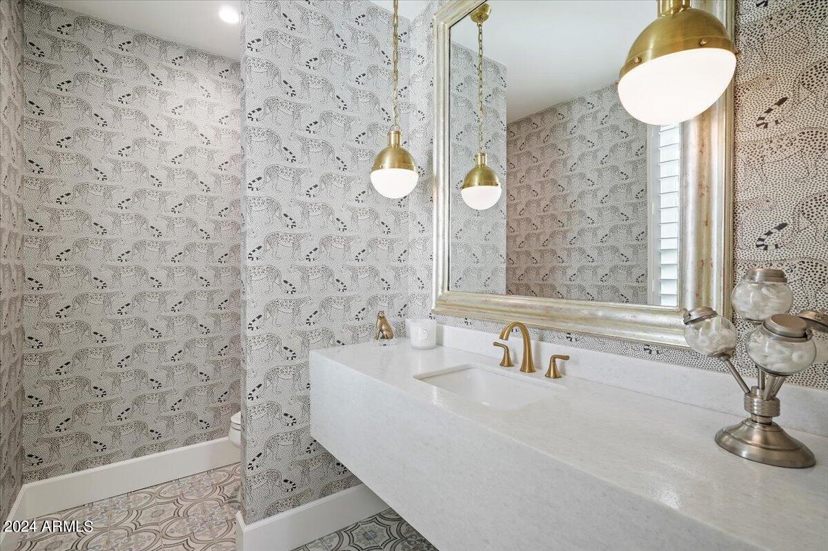 Bathroom with a sink, toilet and a mirror.