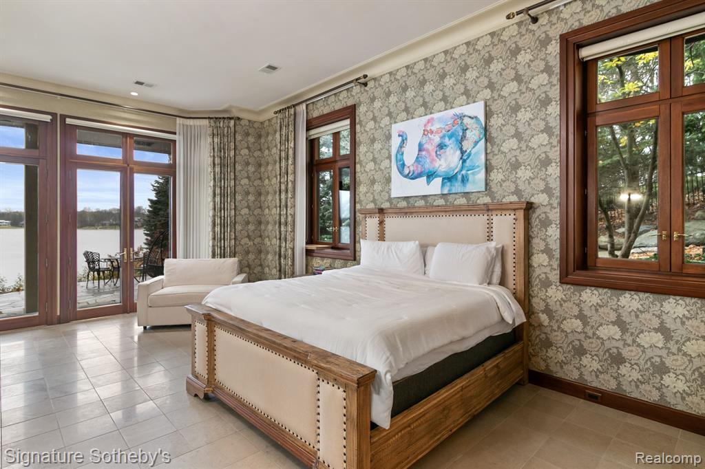 a bedroom with bed, wall paper, tiled floor, white ceiling and windows