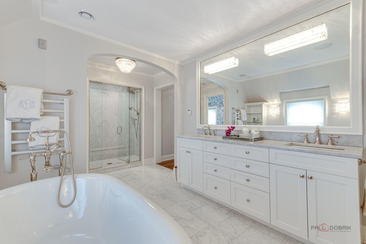 Bathroom with sink, soaking tub, walk-in shower and a tile flooring.