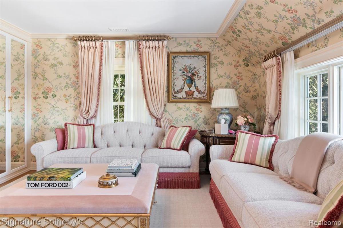 Living room with couches, table and glass windows.