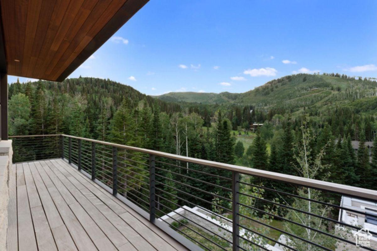 A wooden deck with metal railings.