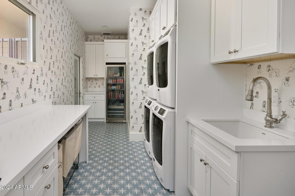 Laundry room with a sink, washer and dryer.