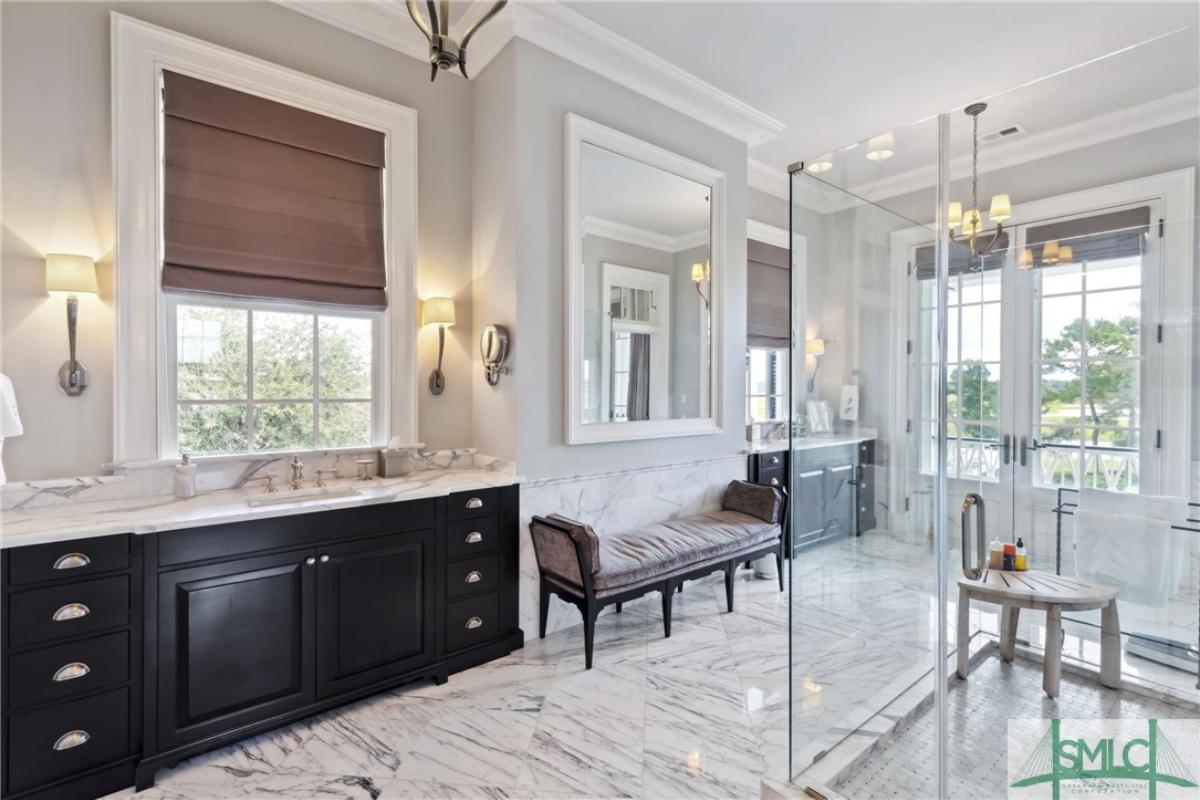 Bathroom with sinks and a walk-in shower.